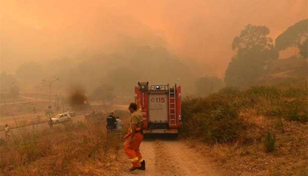 Firefighters attempting to control a fire in the Annunziata district of Messina, northeastern Sicily, last month.