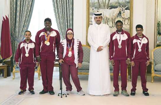 His Highness the Emir Sheikh Tamim bin Hamad al-Thani welcoming players of Qatar Paralympic team who have won in world championships at the Emiri Diwan yesterday.
