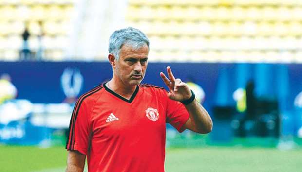 Manchester Unitedu2019s Portuguese coach Jose Mourinho gestures as his players warm up during a training session.