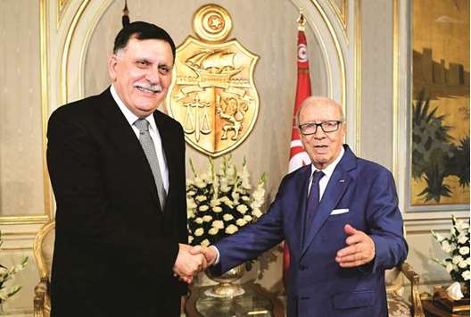 Tunisian President Beji Caid Essebsi (right) meets with Libyau2019s UN-backed Prime Minister Fayez al-Sarraj in Tunis yesterday.
