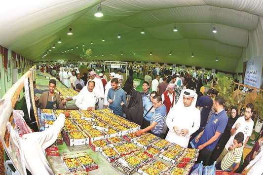 Customers browse through the different varieties of dates on sale at the date festival at Souq Waqif.