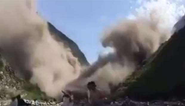 Mud tumbles down a hillside like huge waves during a landslide in Sichuan province, China. Image grab from a video posted in social media.