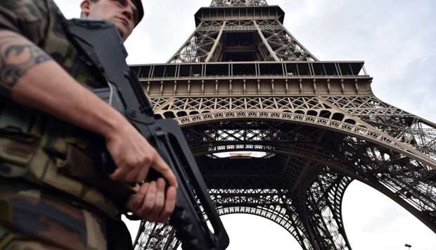 An armed French soldier of the 35th RAP (35e regiment d'artillerie parachutiste), part of Operation Sentinelle, patrolling under at the Eiffel tower in Paris. File photo,  July 20, 2016