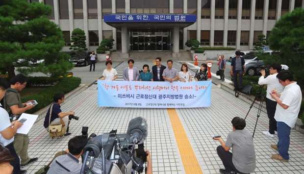 A group of activists working for former slave workers hold a press conference at the district court in the southern city of Gwangju on August 8, 2017 after the court ruled Mitsubishi Heavy Industries should pay compensation to two South Korean former wartime slave workers.
