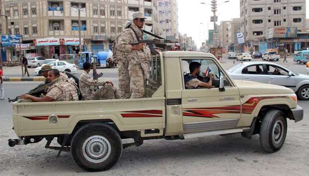 Yemeni Army soldiers patrol a street in Mansoura District, in Aden, Yemen