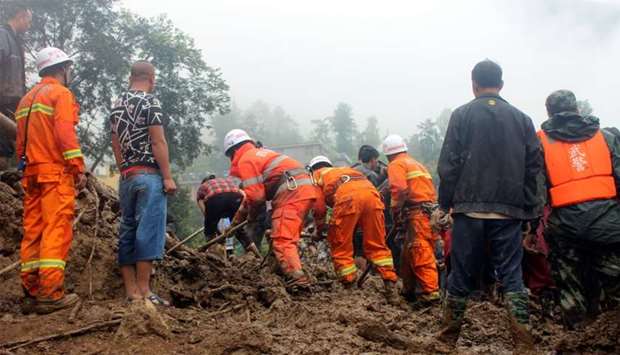 Rescue workers search for survivors at the site in Sichuan province