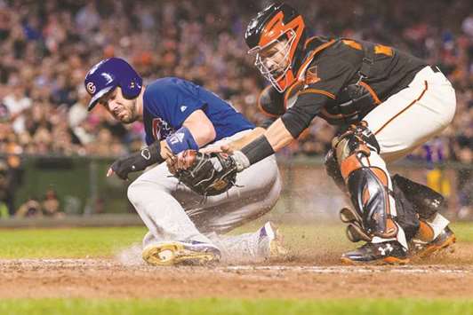 San Francisco Giants catcher Buster Posey (right) tags Chicago Cubs third baseman Kris Bryant in the seventh inning during the Major League Baseball at the AT&T Park in San Francisco on Monday. (USA TODAY Sports)