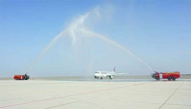A traditional water salute greets Qatar Airways' inaugural flight at Sohar Airport.