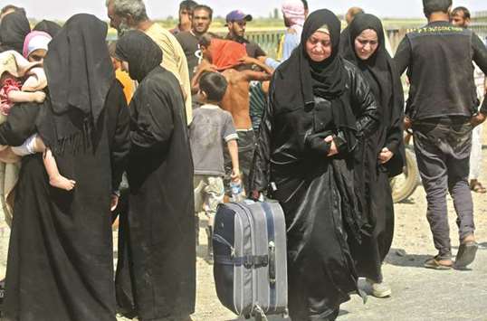 Displaced women and children who fled from the Islamic State groupu2019s stronghold of Raqa arrive in the village of Hawi al-Hawa, less than 2km west of the city.