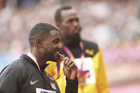 Justin Gatlin (left) poses on the podium with his gold medal during the podium ceremony for the menu2019s 100m event at the IAAF World Championships in London on Sunday. (AFP)