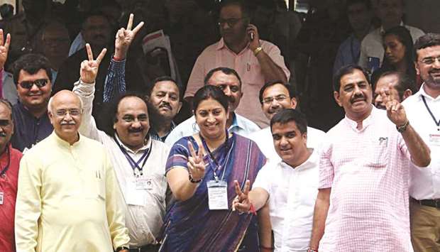 Textiles Minister Smriti Irani flashes a victory sign after casting her vote during the Rajya Sabha election in Gandhinagar yesterday.