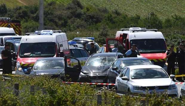 French police and emergency workers intervene on the site after police arrested a suspect on the A16 motorway, near Marquise, northern France, on Wednesday.