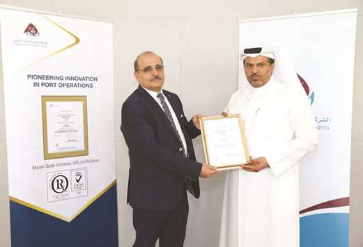 Mwani Qatar chief support services officer Mohamed al-Maadeed receiving the certification during a ceremony held at the companyu2019s headquarters on Tuesday.
