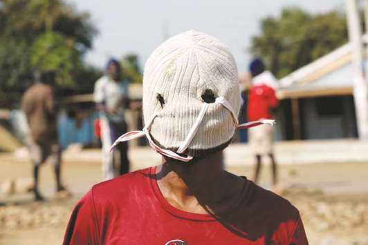 A demonstrator supporting opposition leader Raila Odinga wears a mask as he protests, after Odinga claimed u201cmassiveu201d fraud in this weeku2019s elections, in Kisumu, Kenya.