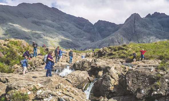 Tourists at the fairy pools, a group of waterfalls in Glen Brittle on the Isle of Skye.