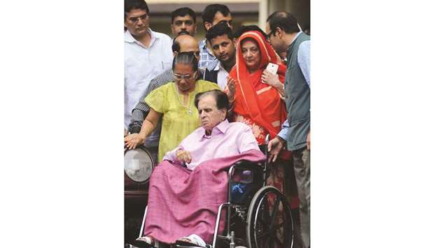 Dilip Kumar is escorted by wife Saira Banu and hospital staff as he leaves after being treated for an illness at the Lilavati Hospital in Mumbai yesterday.