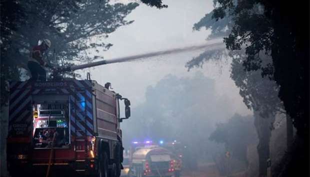Firefighters shooting water from a fire truck close to Monchique in the Portuguese Algarve earlier this week.