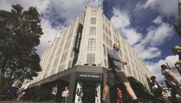 Pedestrians walk past the entrance of a House of Fraser store in central London. The 169-year-old company joined a string of major British retailers who have fallen victim to fierce online competition, rising business rates and stretched household budgets amid Brexit uncertainty.