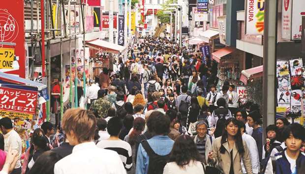 People walk on a street in a busy shopping district in Tokyo. Japanu2019s private consumption, which accounts for about 60% of the GDP, was the biggest contributor, rising 0.7% on brisk demand for cars and home appliances.