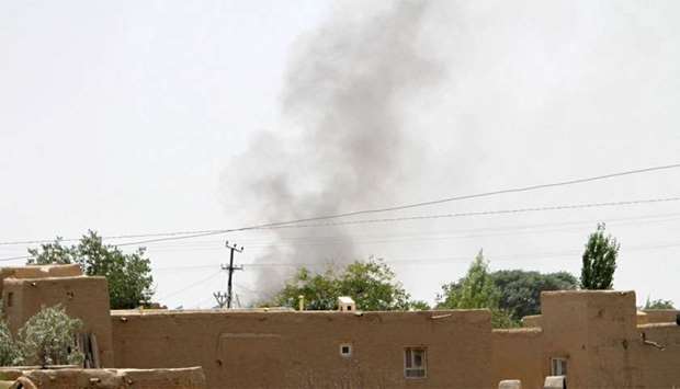 Smoke rises from a residential area where gun battle is going on between Taliban and Afghan forces in Ghazni province