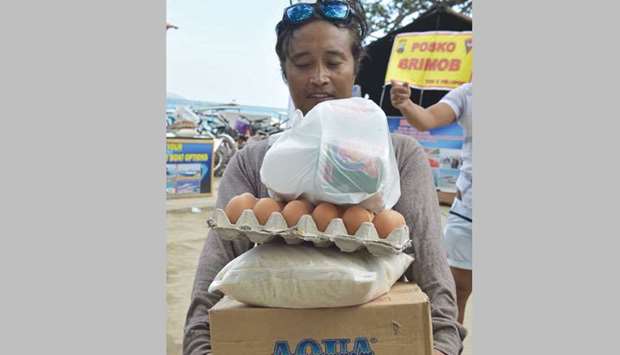 A man receives food supplies on Gili Air island, west Nusa Tenggara, yesterday.