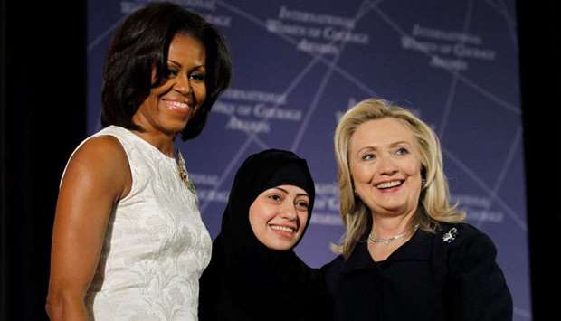US Secretary of State Hillary Clinton and First lady Michelle Obama (L) congratulate Samar Badawi of Saudi Arabia during the State Department's 2012 International Women of Courage Award winners ceremony in Washington on March 8, 2012.