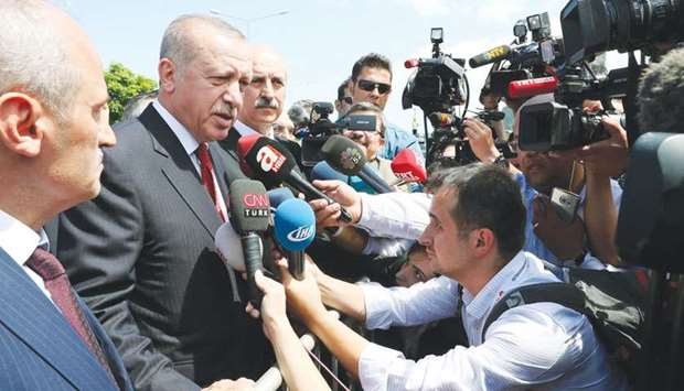 This handout picture released by the Turkish Presidential Press Service shows Erdogan speaking with journalists during his visit to the Black Sea province of Ordu.