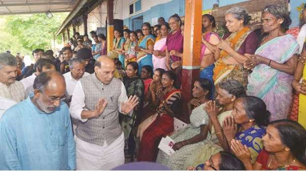 Federal Home Minister Rajnath Singh interacts with flood victims at a relief camp in Ernakulam, Kerala yesterday. Accompanying him are Kerala Chief Minister Pinarayi Vijayan and federal Minister of State for Culture and Tourism Alphons Kannanthanam.