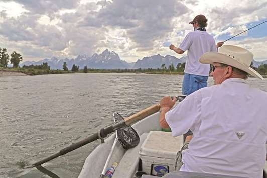 ROWING: Dennis Anderson, foreground, rows the Snake River in Grand Teton National Park while his son, Trevor, casts.
