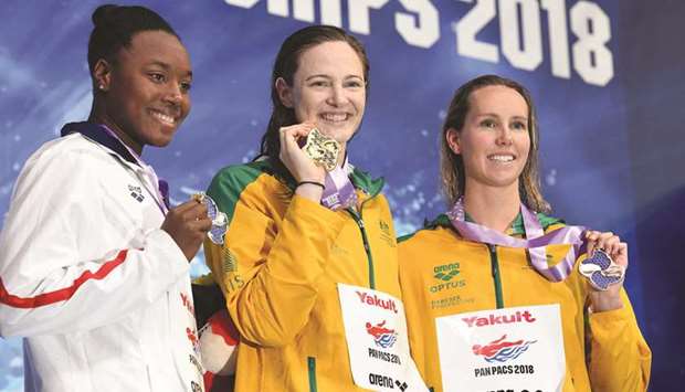 Womenu2019s 50m freestyle gold medallist Cate Campbell of Australia (centre) poses with silver medallist Simone Ashley Manuel of the US (left) and bronze medallist Emma McKeon of Australia on the podium of the Pan Pacific Swimming Championships 2018 in Tokyo yesterday. (AFP)