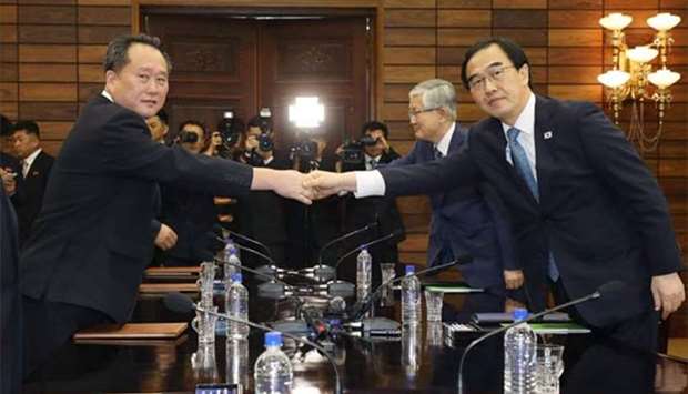 South Korean Unification Minister Cho Myoung-gyun (right) shakes hands with his North Korean counterpart Ri Son Gwon during their meeting at the border truce village of Panmunjom on Monday.