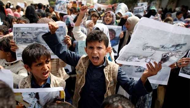 Boys demonstrate outside the offices of the United Nations in Sanaa on Monday to denounce last week's air strike that killed dozens including children in the northwestern Yemeni province of Saada.