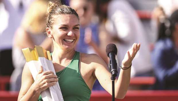 Simona Halep of Romania is all smiles after winning the  Rogers Cup in Montreal on Sunday. (AFP)