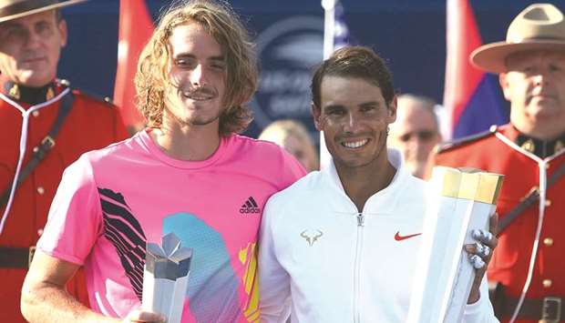 Champion Rafael Nadal (right) of Spain and runner-up Stefanos Tsitsipas of Greece pose with their trophies after the Toronto Masters final at the Aviva Centre in Toronto, Canada, on Sunday. (AFP)