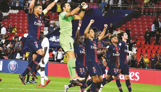 Paris Saint-Germain players celebrate after winning the match against Caen in the French Ligue 1 at the Parc des Princes, in Paris, on Sunday night. (AFP)