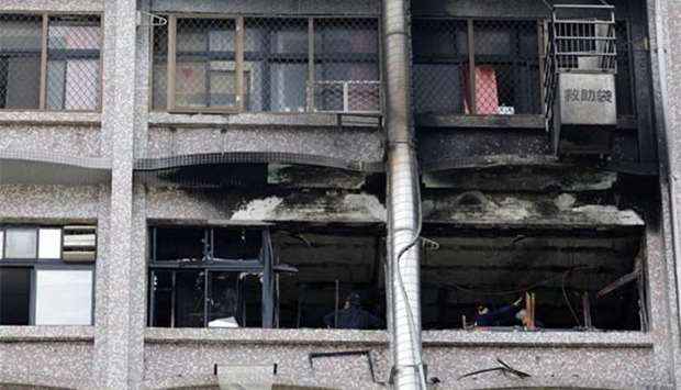 Fire inspectors view damage after a fire broke out at the Taipei Hospital on Monday.