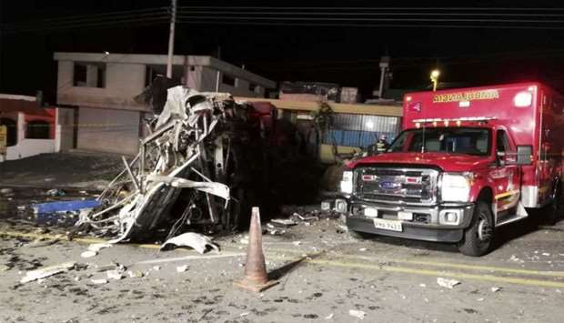 Photo released by the Fire Brigade of Quito showing an ambulance at the scene of an accident where a bus crashed into another vehicle