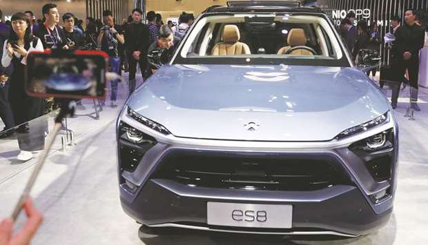 Visitors check NIO ES8 car displayed during a media preview of the Auto China 2018 in Beijing. The Chinese automaker plans to go public on the New York Stock Exchange to raise $1.8bn..
