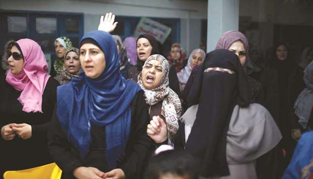 Palestinian UNRWA employees take part in a protest against jobs termination by UNRWA inside its headquarters in Gaza City.