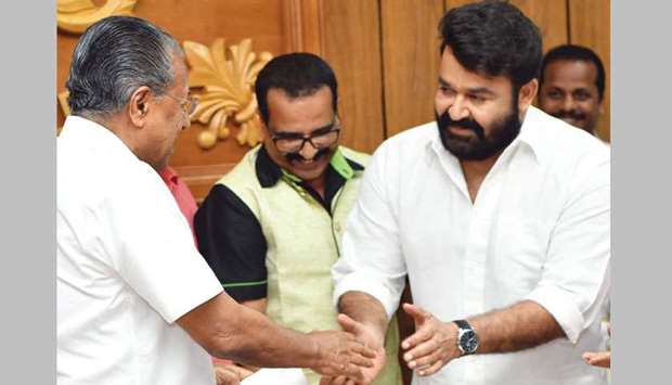 Actor Mohanlal hands over a cheque for Rs2.5mn to Chief Minister Pinarayi Vijayan.