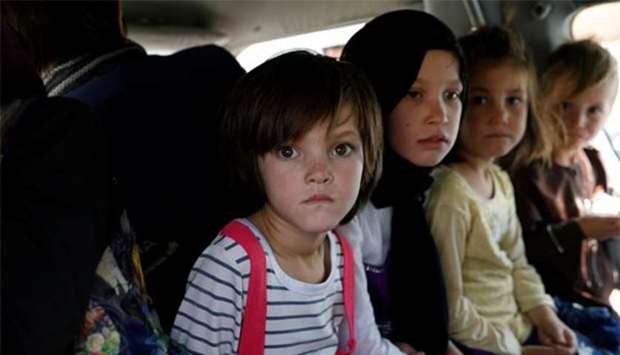Afghan children ride in a vehicle as they flee their houses following heavy fighting in Ghazni province.