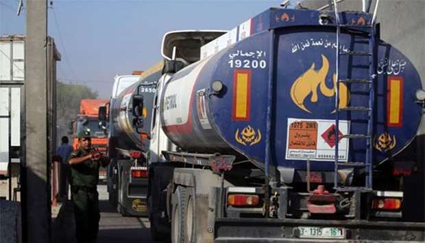 A member of Palestinian security forces gestures as a fuel tanker arrives at Kerem Shalom crossing in Rafah in Gaza Strip on Wednesday.
