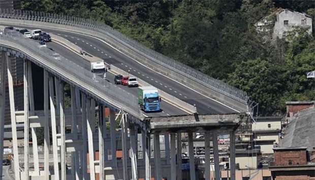 Abandoned vehicles are seen on the Morandi bridge on Wednesday, a day after a section collapsed in the north-western Italian city of Genoa.