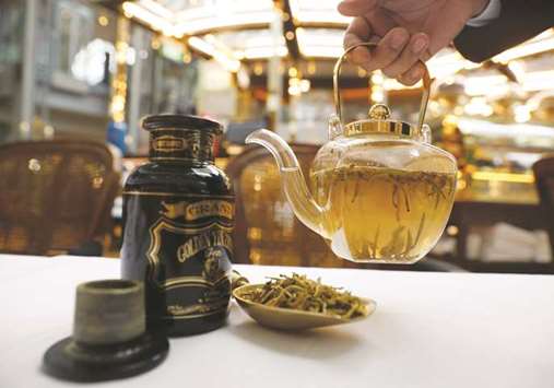 A staff member shows a pot of TWG Teau2019s Golden Yin Zhen tea that costs $654 (S$900) per 45g of tea leaves at their tea shop in Singapore.