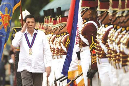 Philippine President Rodrigo Duterte reviews an honour guard in a file picture.