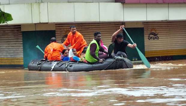 Indian navy and rescue personnel evacuate local residents in an boat at Aluva