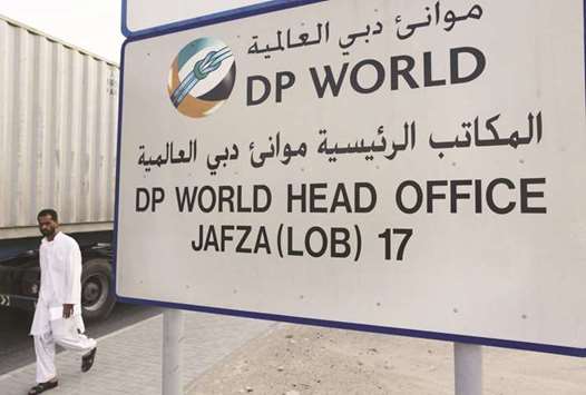 A man walks past a DP World sign in Dubai (file). The company, one of the worldu2019s biggest port operators, posted a 2.1% drop in first-half net profit yesterday, and cautioned about geopolitical risks and recent changes to trade policies.