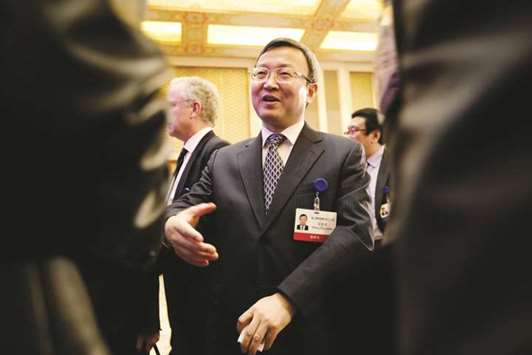 Chinese Vice Commerce Minister and Deputy China International Trade Representative Wang Shouwen chats with participants after a speech at the annual session of China Development Forum 2018 at the Diaoyutai State Guesthouse in Beijing. China will send a senior negotiator to the United States in late August to resume trade talks, its commerce ministry said yesterday, the first public meeting on the dispute in weeks as the trade conflict intensifies.