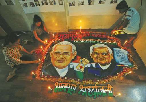 Students place candles around a painting featuring Atal Bihari Vajpayee to pay him homage, in Mumbai yesterday.