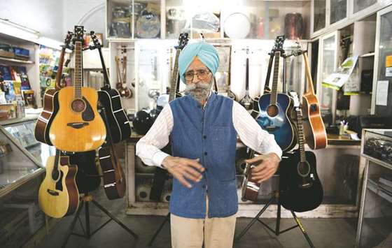This picture taken on June 19, 2018 shows Ajit Singh, 86, owner of the music shop who fixed John Lennonu2019s guitar and performed at George Harrisonu2019s 25th birthday party when the Beatles stayed at an ashram in nearby Rishikesh 50 years ago in 1968, posing for a photo in Dehradun in northern India.